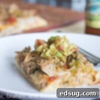 Pork Carnitas Pizza 3 A delicious Carnita Pizza with melted cheese and fresh toppings, ready to eat.