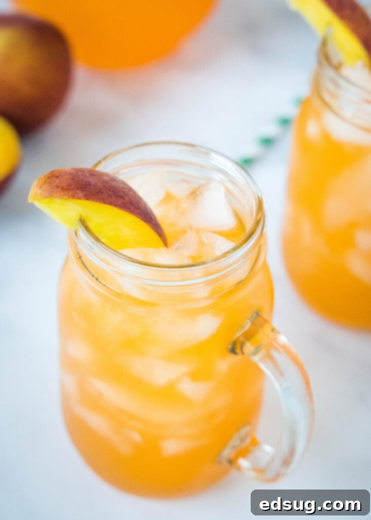 Golden Peach Zest 3 looking down on a glass of ice with peach lemonade