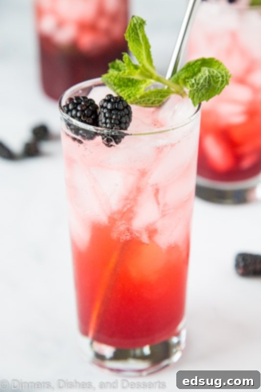 Blackberry Lime Punch front and center topped with mint and fresh berries