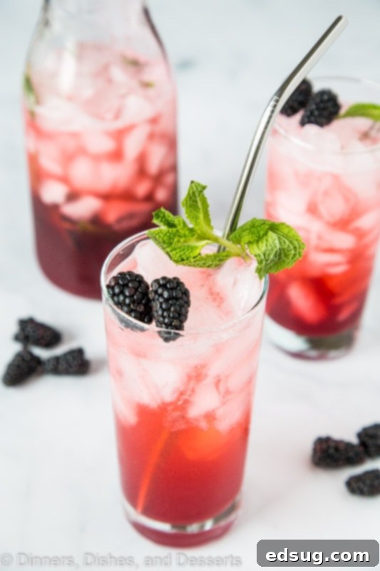 Blackberry Mint Lime Punch with pitcher of punch in background