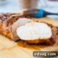 Chargrilled Turkey Tenderloin 8 A piece of turkey sitting on top of a wooden cutting board, ready to be prepared.