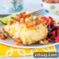 A plate of food on a table, with chicken and Lime