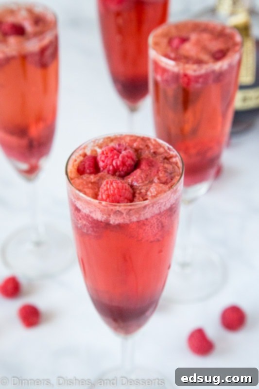Mimosas made with fresh raspberries, chambord, champagne and raspberry sorbet