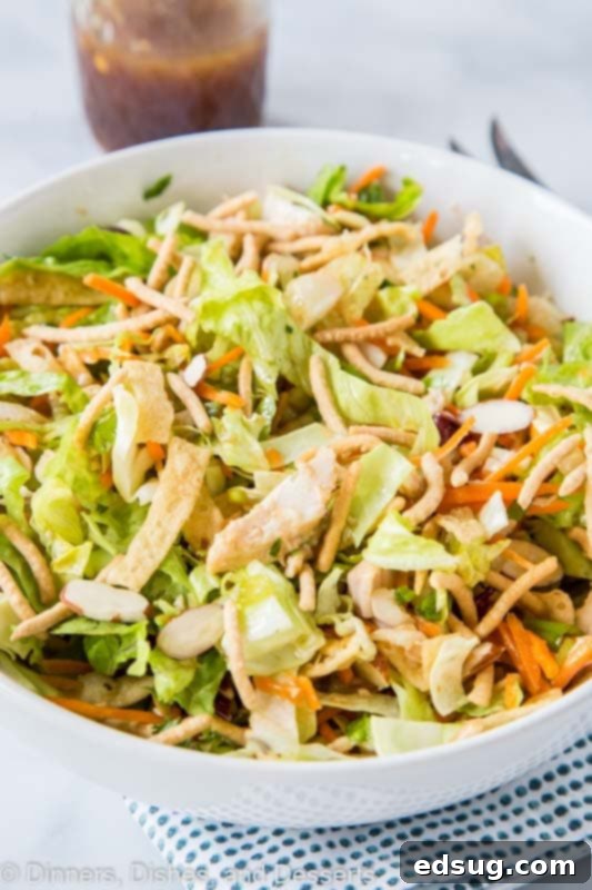 Crispy Asian Chicken Salad 3 Close-up of a large bowl of Chinese Chicken Salad, highlighting the shredded rotisserie chicken, crisp vegetables, and crunchy toppings.