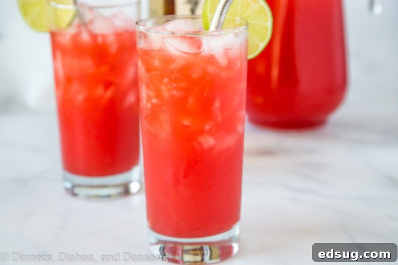 Reggae Rhythm Rum Punch 4 Ingredients for Easy Rum Punch laid out on a table: orange juice, pineapple juice, fruit punch, lime juice, and a bottle of spiced rum.