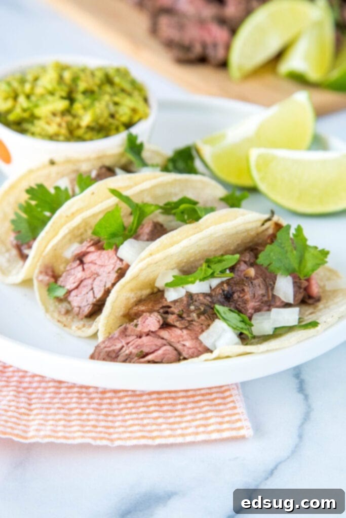 Zesty Flank Steak Tacos 2 Flank Steak Tacos topped with onions and fresh cilantro
