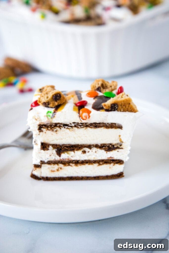 Icebox Cake made with ice cream sandwiches and homemade whipped cream, garnished with chocolate and caramel drizzles and mini M&Ms