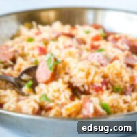 Hearty Skillet Sausage and Rice 5 A bowl of food with rice and vegetables
