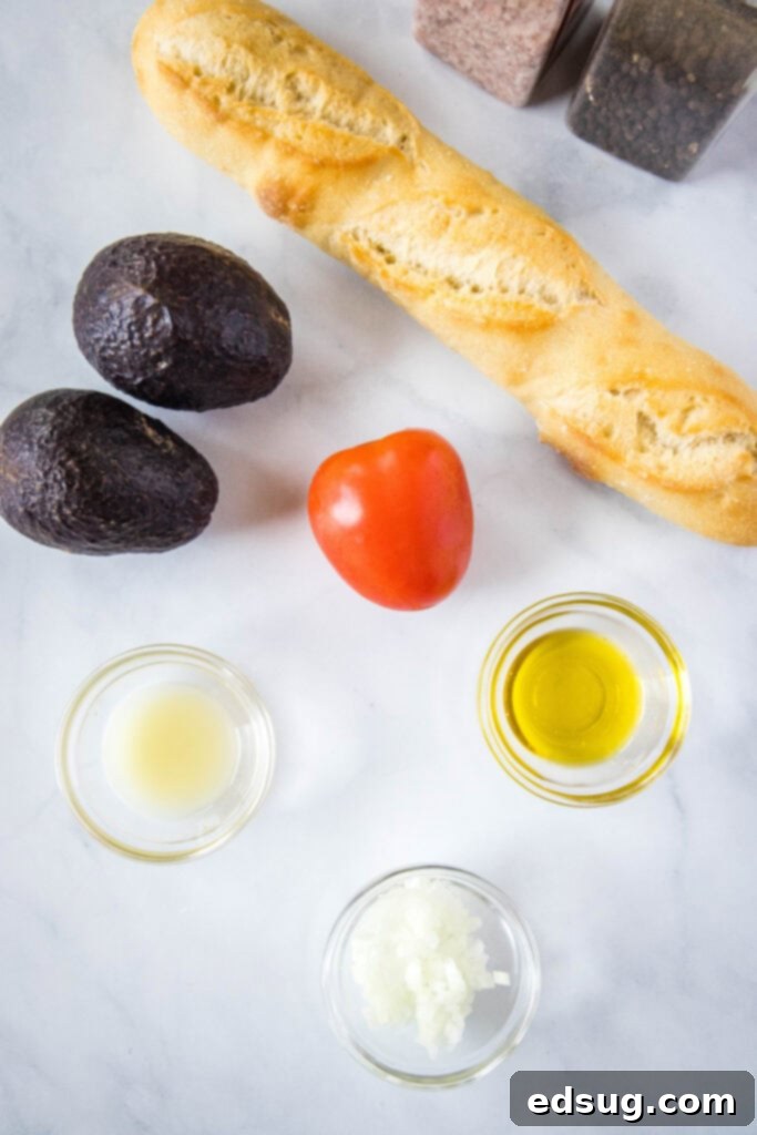 Fresh ingredients for avocado bruschetta, including ripe avocados, tomatoes, onion, and lime, in a rustic setting.
