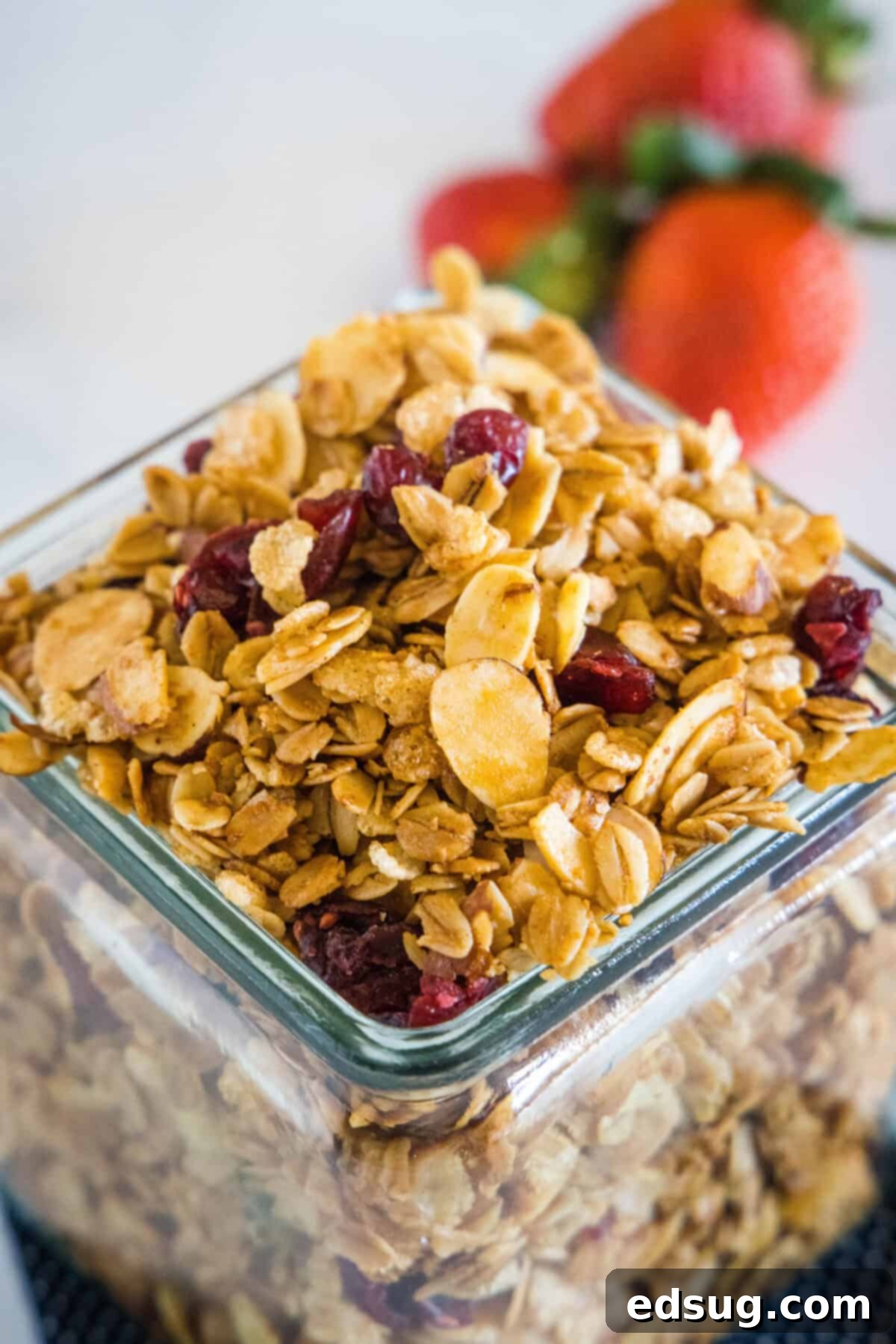 Homemade Vanilla Almond Granola Vanilla almond granola in a clear glass jar, showcasing its golden color and crunchy texture with visible oats and nuts