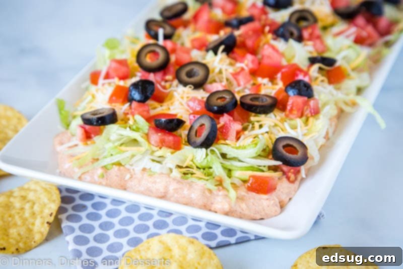 Our favorite taco dip. Super easy to make, delicious creamy layers and perfect game day snack!