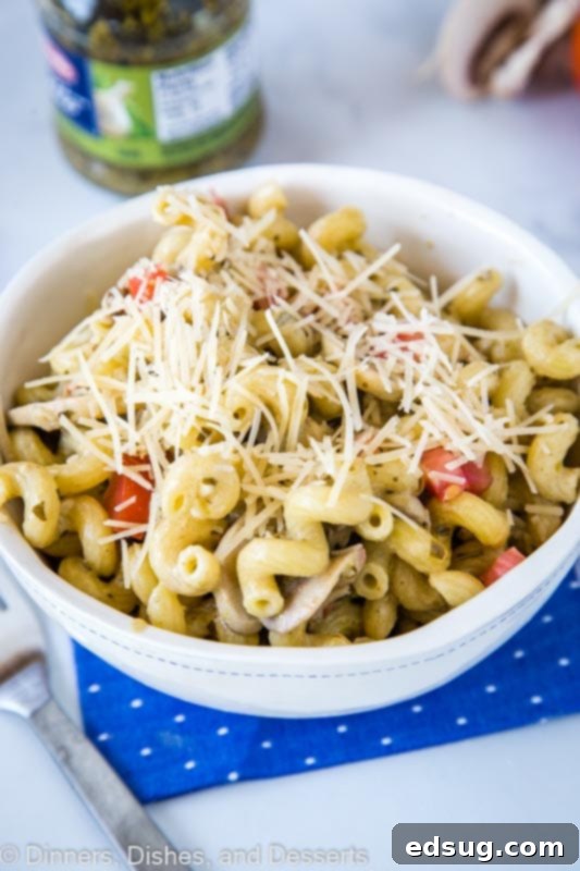 Signature Pesto Cavatappi 3 A bowl of pasta topped with cheese