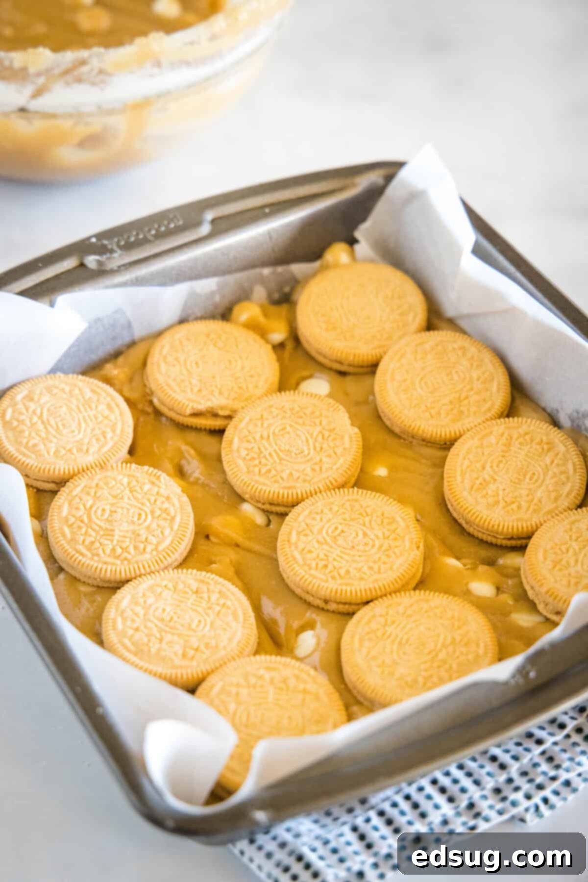 arranging golden oreos over blondie batter