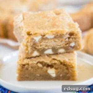 close up golden oreo blondies stacked on a white plate