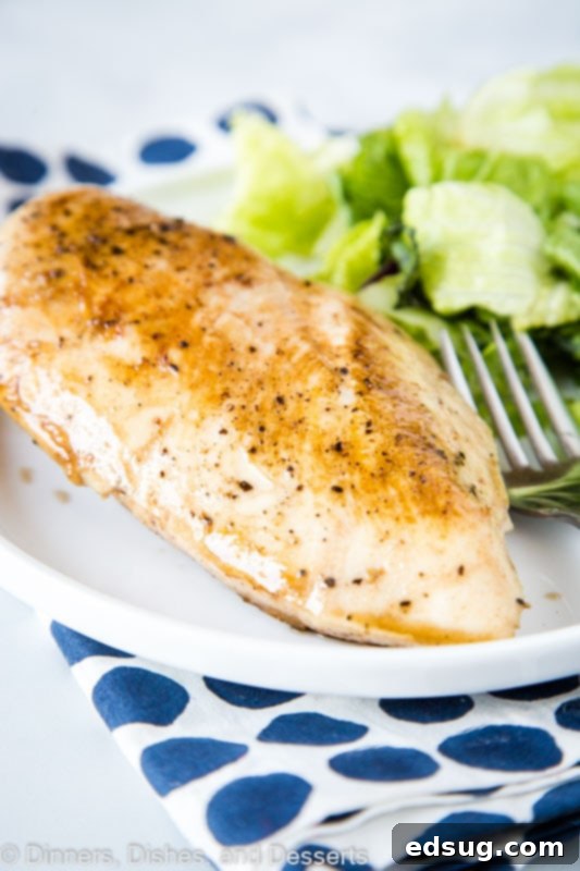 Ultimate Sous Vide Chicken Breast 2 Perfectly seared sous vide chicken breast on a cutting board, ready to serve.