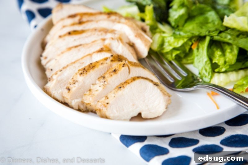 Ultimate Sous Vide Chicken Breast 5 Four perfectly cooked sous vide chicken breasts on a cutting board, ready for searing.