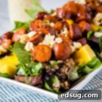 A plate full of salad with sausage