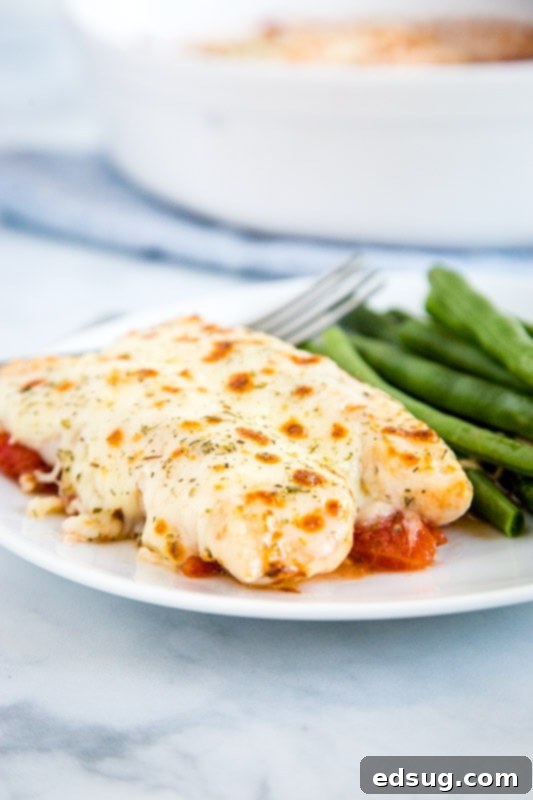 Garlic Tomato Baked Chicken plated with green beans