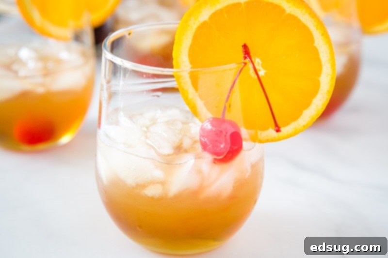 Classic Amaretto Sour Recipe 5 Amaretto Sour Recipe - a classic cocktail that is so easy to make an absolutely delicious! With just 4 ingredients it is so simple to make, it will become your go-to cocktail!  A beautifully composed shot showing the Amaretto Sour in a glass, alongside other cocktail ingredients and tools.