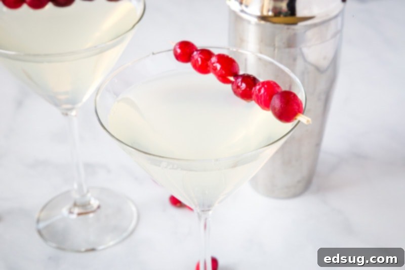 A festive spread featuring Winter White Cosmo cocktails, garnished with fresh cranberries, ideal for holiday entertaining and seasonal celebrations.