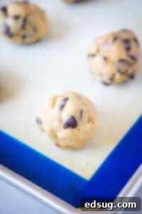Rolled balls of cookie dough on a baking sheet