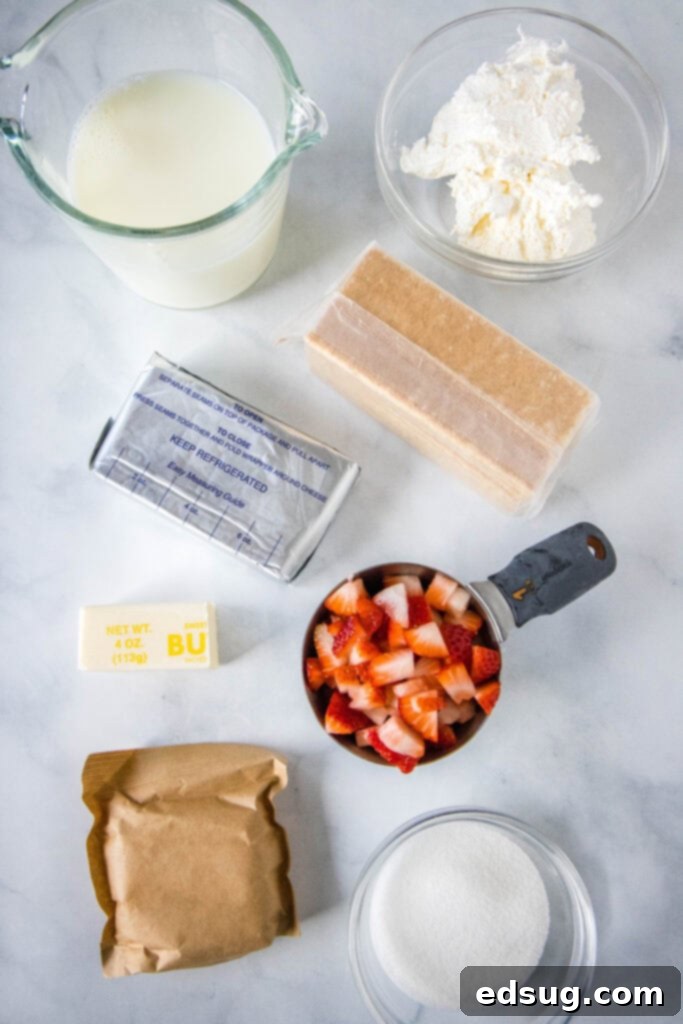 Collection of fresh ingredients for strawberry lush dessert, including strawberries, graham crackers, cream cheese, and whipped cream.
