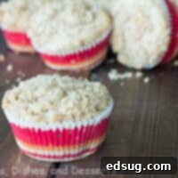 Peachy Cobbler Muffins 3 A perfectly baked peach cobbler muffin, golden-brown with a crumbly topping.
