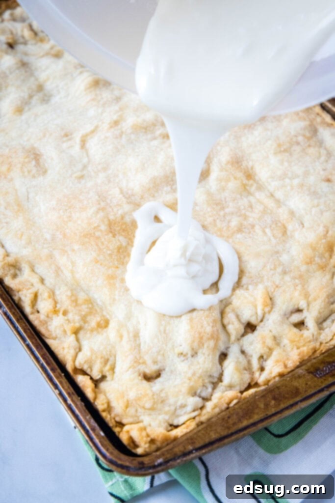 Apple Crumble Bars 5 pouring glaze over baked apple bars