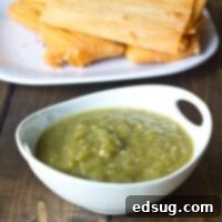 A bowl of vibrant green chili sauce, ready to be served.