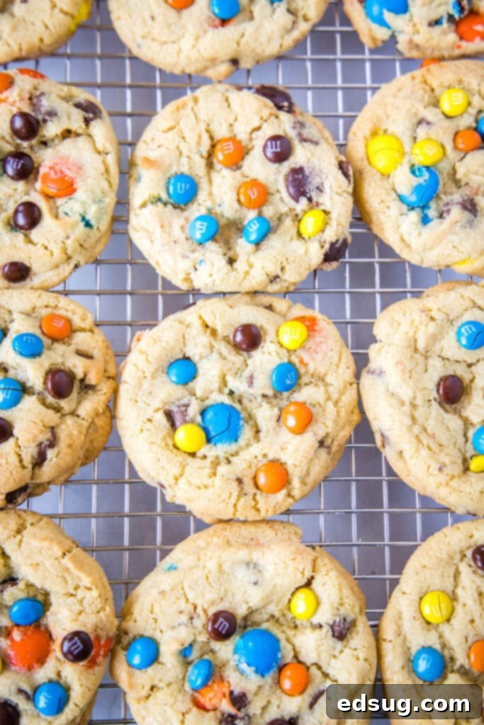 Looking down on a cooling rack filled with freshly baked M&M cookies