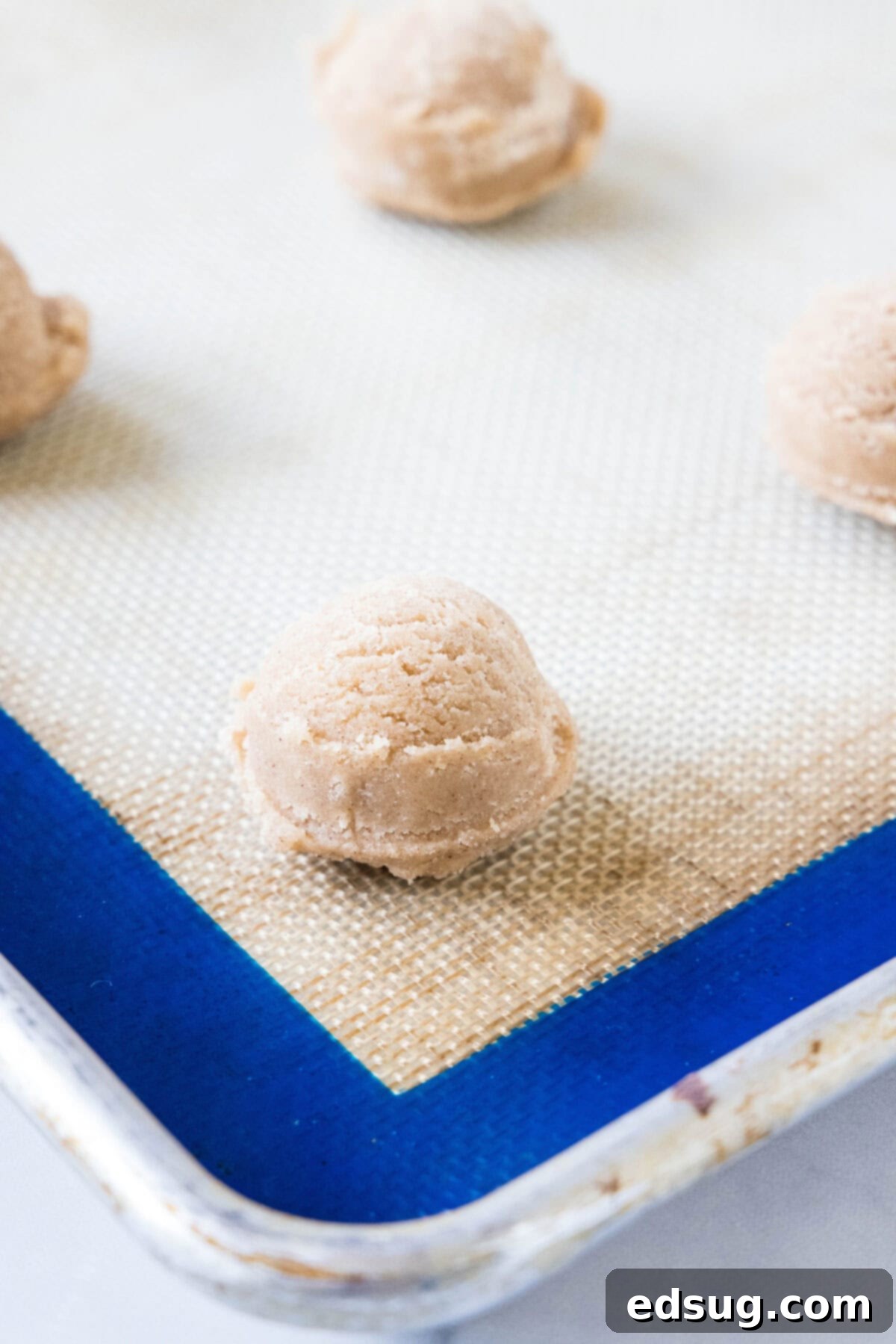 Spiced Apple Cider Cookies 2 Apple cider cookie dough portioned into balls on a silpat-lined baking sheet.