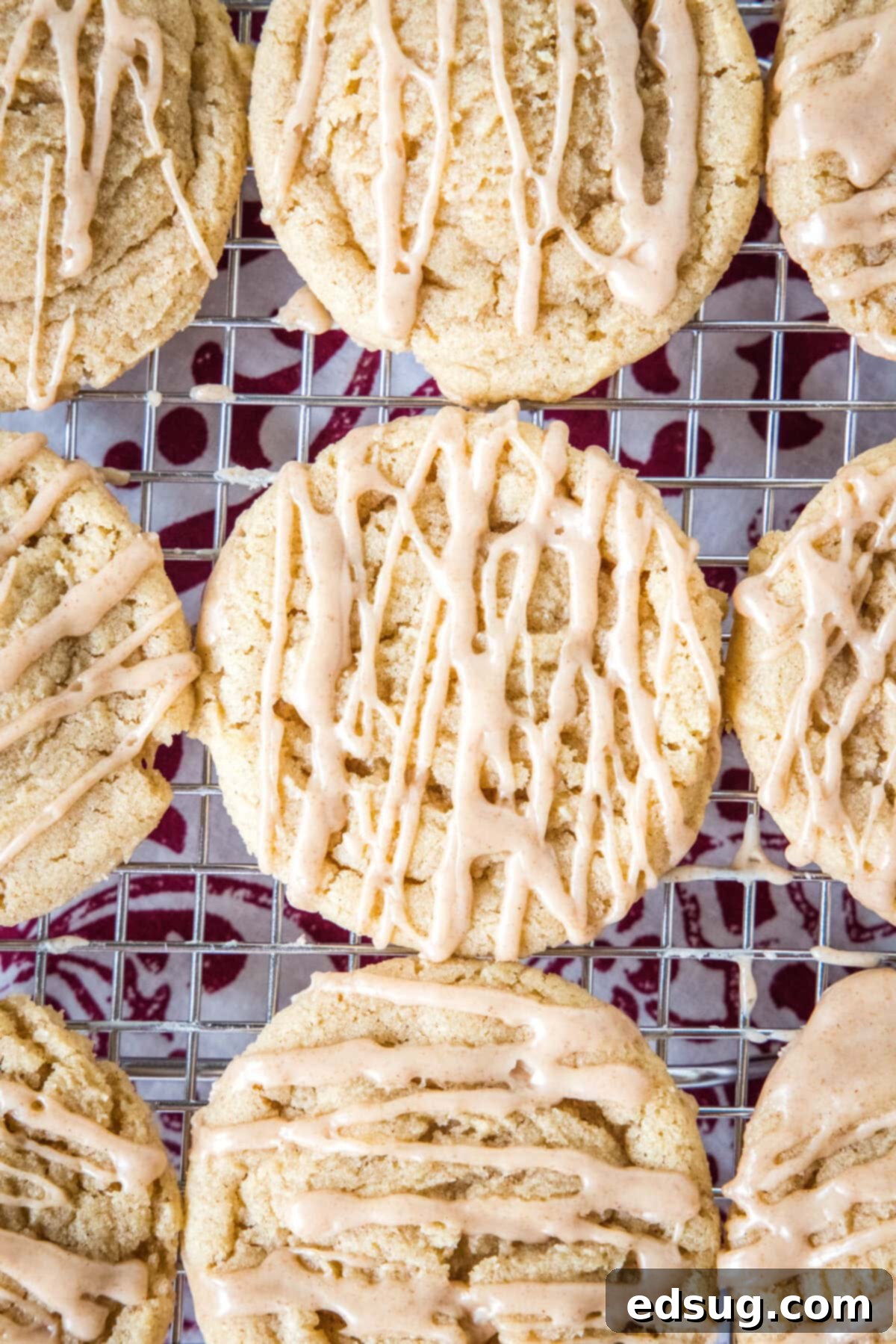 Spiced Apple Cider Cookies 5 Overhead view of apple cider cookies drizzled with cider glaze on a wire rack.