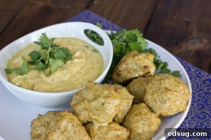 Meatball Masala 4 Three perfectly golden-brown Indian chicken meatballs on a white plate