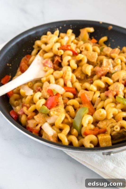 Creamy Chicken Fajita Pasta is a one-pan meal that gets on the table fast! Perfect for a quick and easy weeknight dinner.