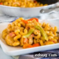 A bowl of creamy chicken fajita pasta with ingredients like chicken and pasta.