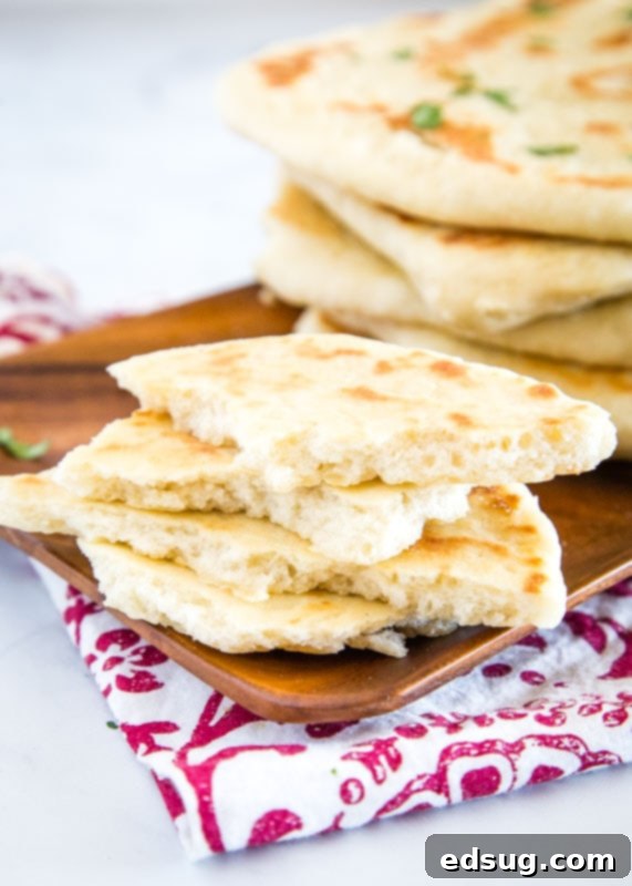 Pillowy Soft Naan 4 Indian style flat bread is easy to make at home and great brushed with garlic butter