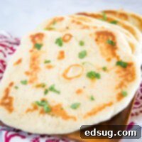 Pillowy Soft Naan 6 Naan Bread - This homemade naan bread is a soft and chewy Indian style flatbread.  A simple and easy dough that makes for the most delicious bread!  It is great to brush with butter and garlic for an easy garlic naan recipe.