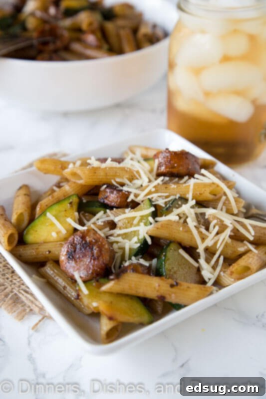 A vibrant bowl of balsamic pasta with chicken sausage and mixed vegetables, garnished with fresh herbs, ready to be served for a delicious and healthy meal.