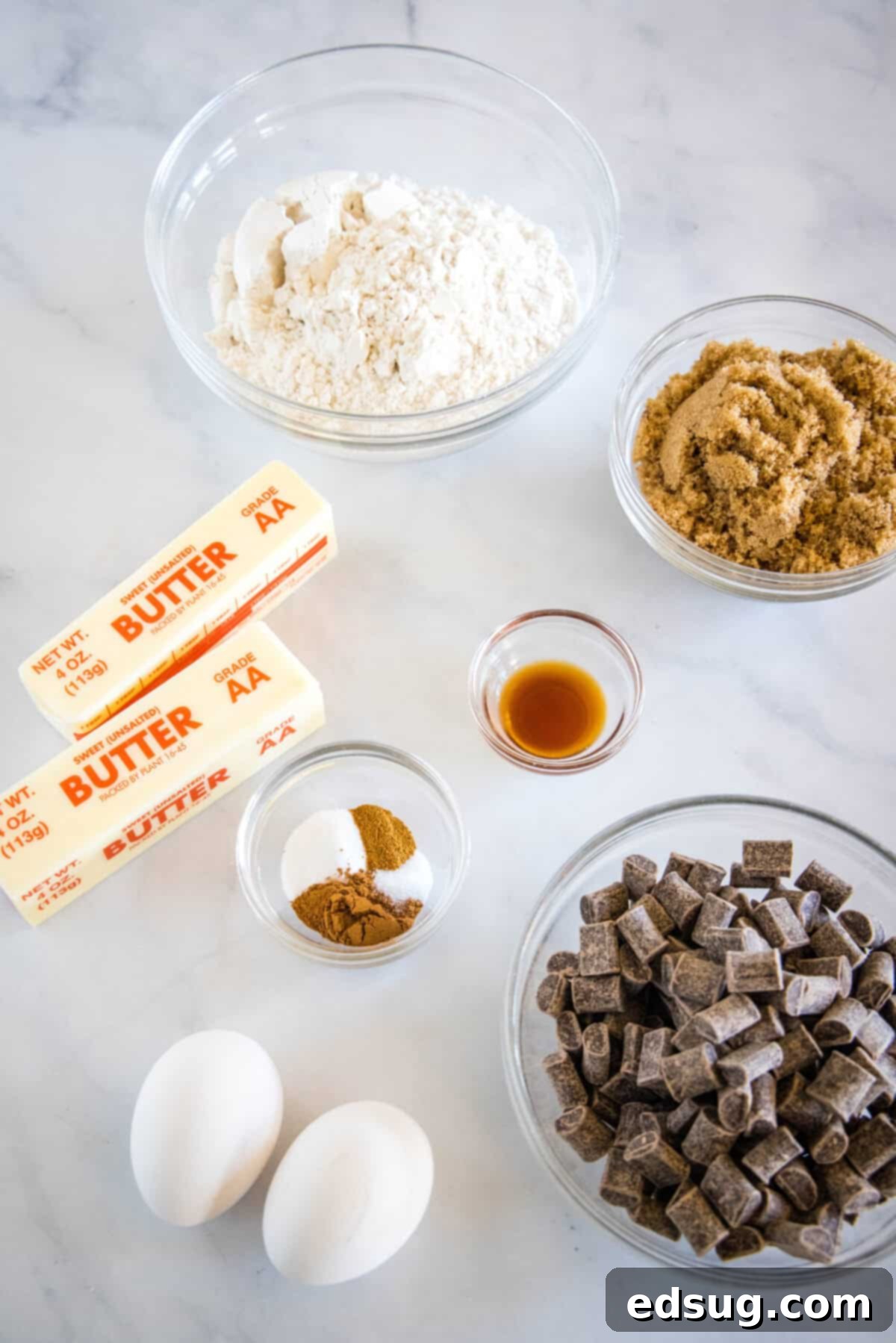 Spiced Mexican Chocolate Chip Cookies 3 Ingredients laid out for Mexican Chocolate Chip Cookies, including butter, sugar, flour, spices, and chocolate.