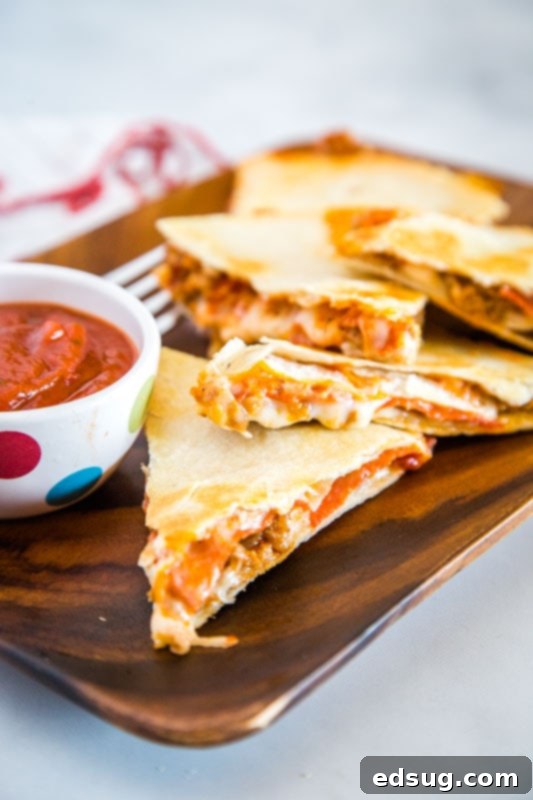 Close-up of a Pizza Quesadilla with melted cheese and pepperoni, ready to be cooked.
