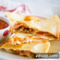 Pizza Quesadilla - Turn your favorite pizza into a quesadilla for a quick and easy dinner tonight!  Fill with pepperoni, sausage, peppers, black olives, or whatever your favorite is!  