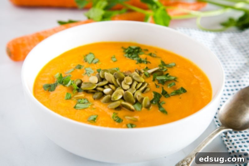 Carrot Ginger Soup - Smooth and creamy carrot soup with ginger, turmeric, garlic, and chicken broth.  Healthy, comforting, and and the perfect way to brighten up a cold day!