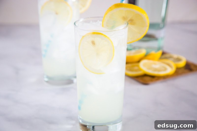 Several glasses of Tom Collins cocktails arranged beautifully, emphasizing their crisp, clear appearance and refreshing nature, ready for a gathering.