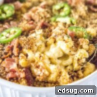 Close-up of a spoon scooping creamy Jalapeño Popper Mac and Cheese from a baking dish.