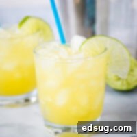 A glass of margarita with slice of lime, with Margarita