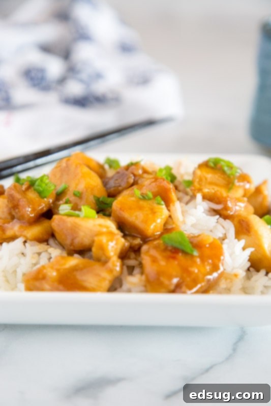 General Tso's Crispy Classic 3 Close-up of crispy, pan-fried chicken pieces coated in a glossy General Tso sauce, ready to be served.
