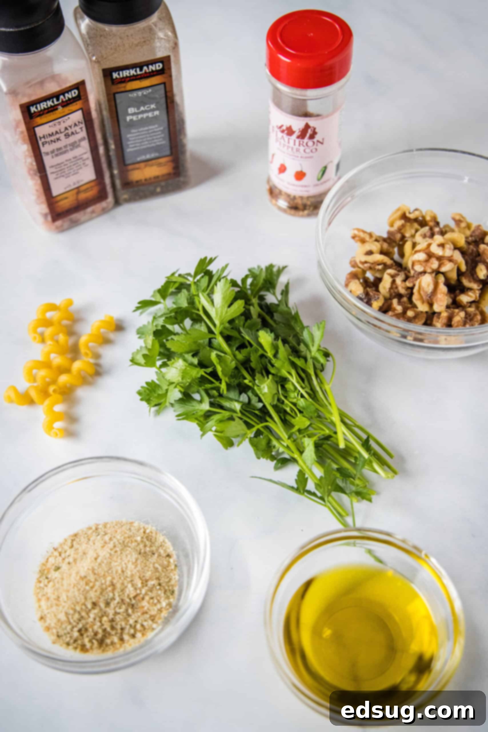 This toasted walnut pasta is an easy, flavorful, and filling 15-minute pasta recipe with crunchy walnuts, breadcrumbs, garlic, and chili. Fresh ingredients laid out for making toasted walnut pasta, including walnuts, breadcrumbs, garlic, and olive oil.