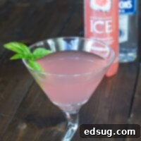 Ruby Basil Martini 1 A vibrant pink Grapefruit Basil Martini in a martini glass with a basil garnish.