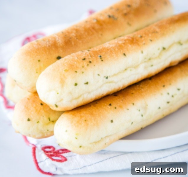 A close up of food, with Bread and Breadstick
