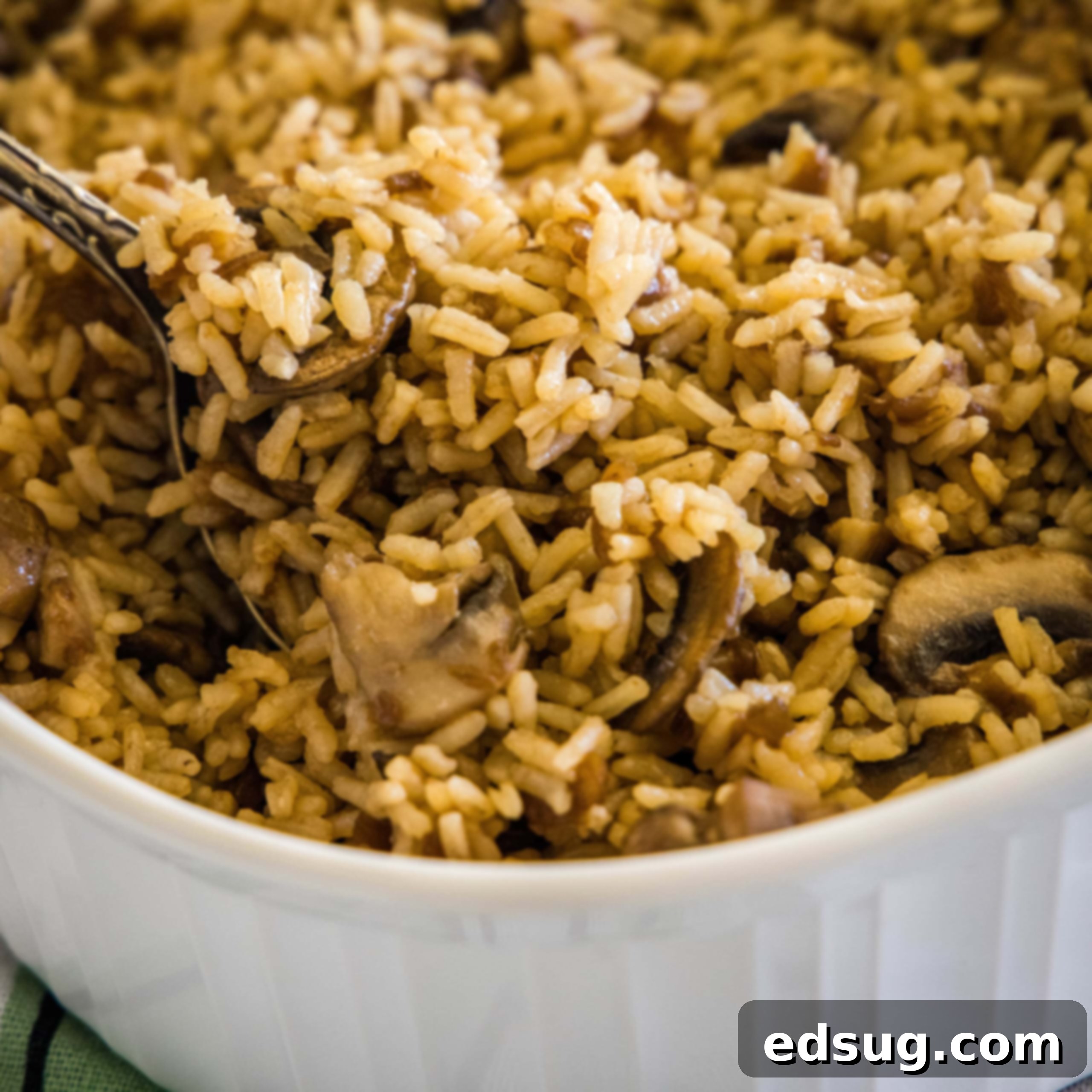 close up french onion rice scooping out of baking dish